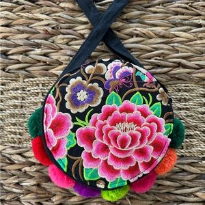 Floral embroidered round bag.